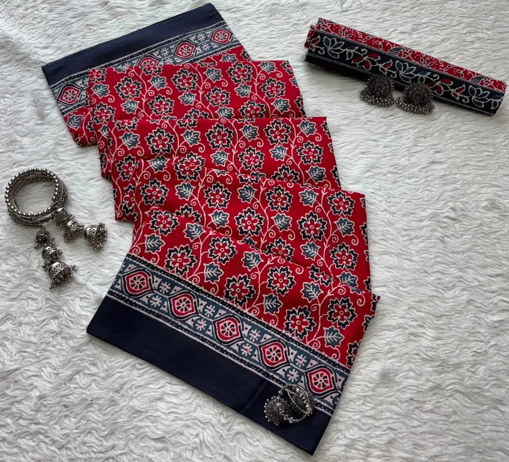 Red and navy blue ajrakh print mal cotton saree flat lay with silver jhumkas