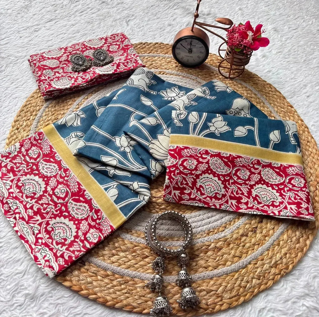 Flat lay of blue and red mal mal cotton saree on jute mat with silver bangles