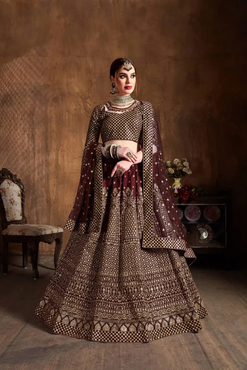 Model wearing maroon raw silk lehenga with gold embroidery and matching dupatta