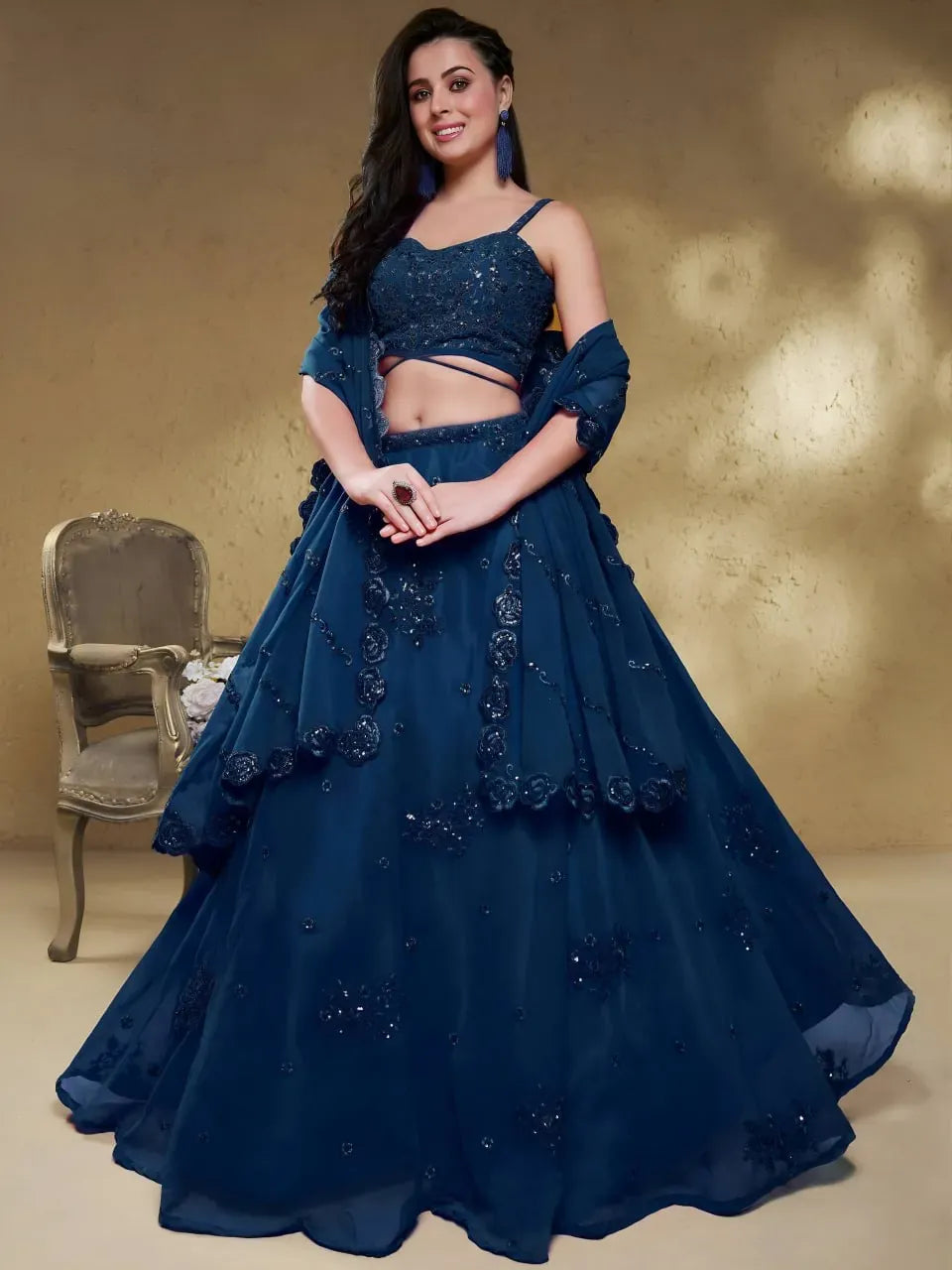 Front facing model wearing midnight blue georgette lehenga choli with sequin work