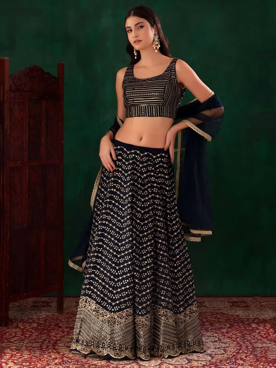 Model wearing midnight blue georgette lehenga with heavy zari and sequins embroidery
