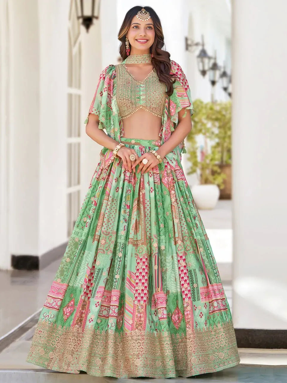 Front view of model wearing mint green floral printed lehenga choli