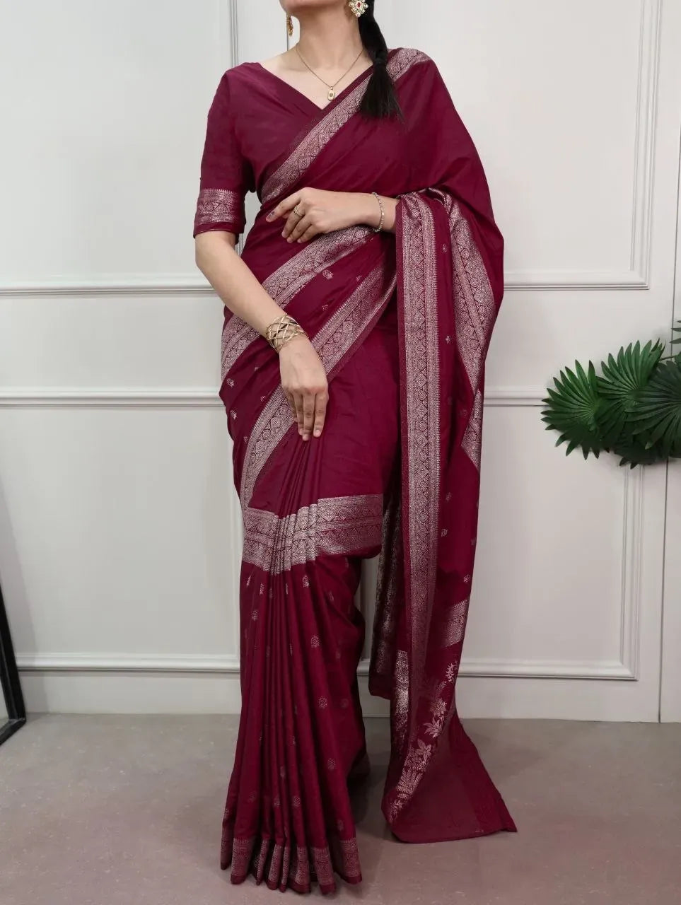Full view of model wearing traditional maroon zari woven saree