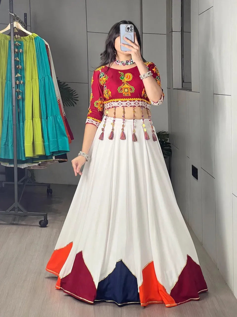 Full body view of woman in traditional mirror work lehenga choli