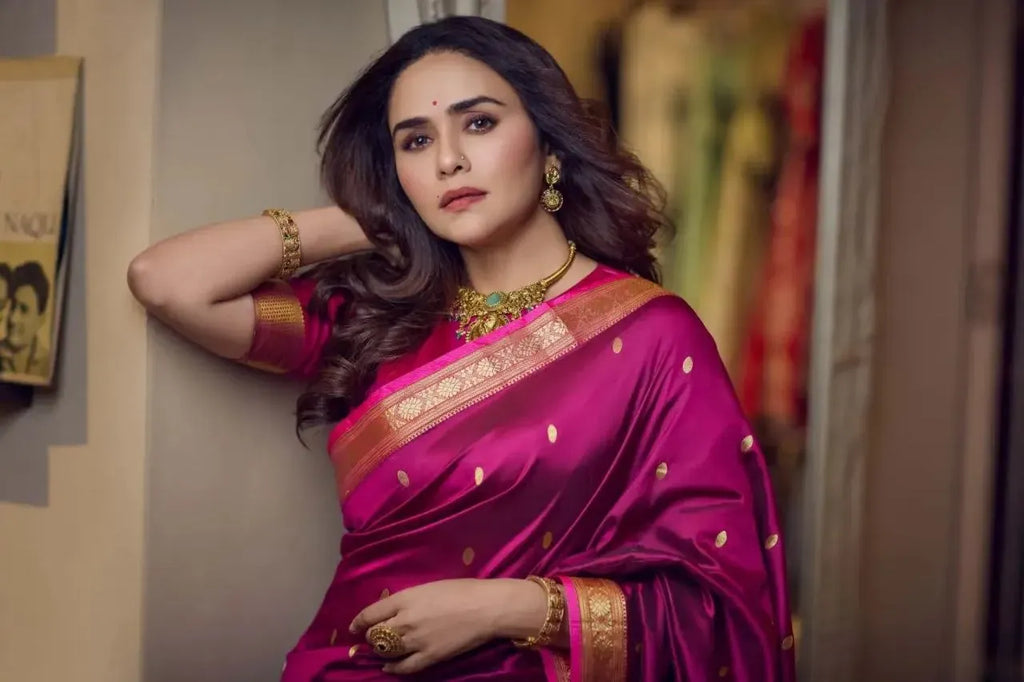 Model wearing hot pink traditional paithani silk saree with gold jewelry