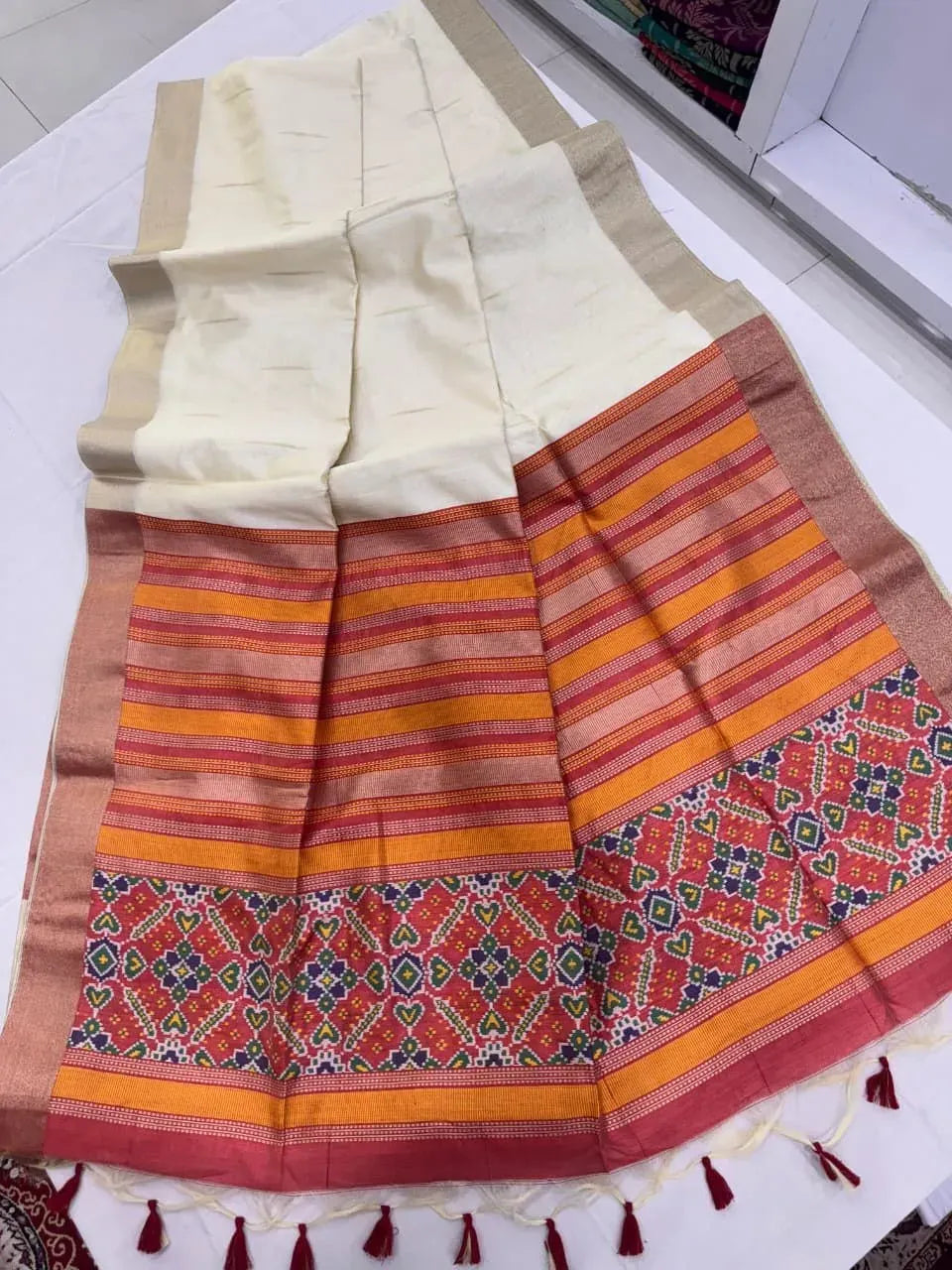Off-white and red khadi raw silk saree with patola pallu