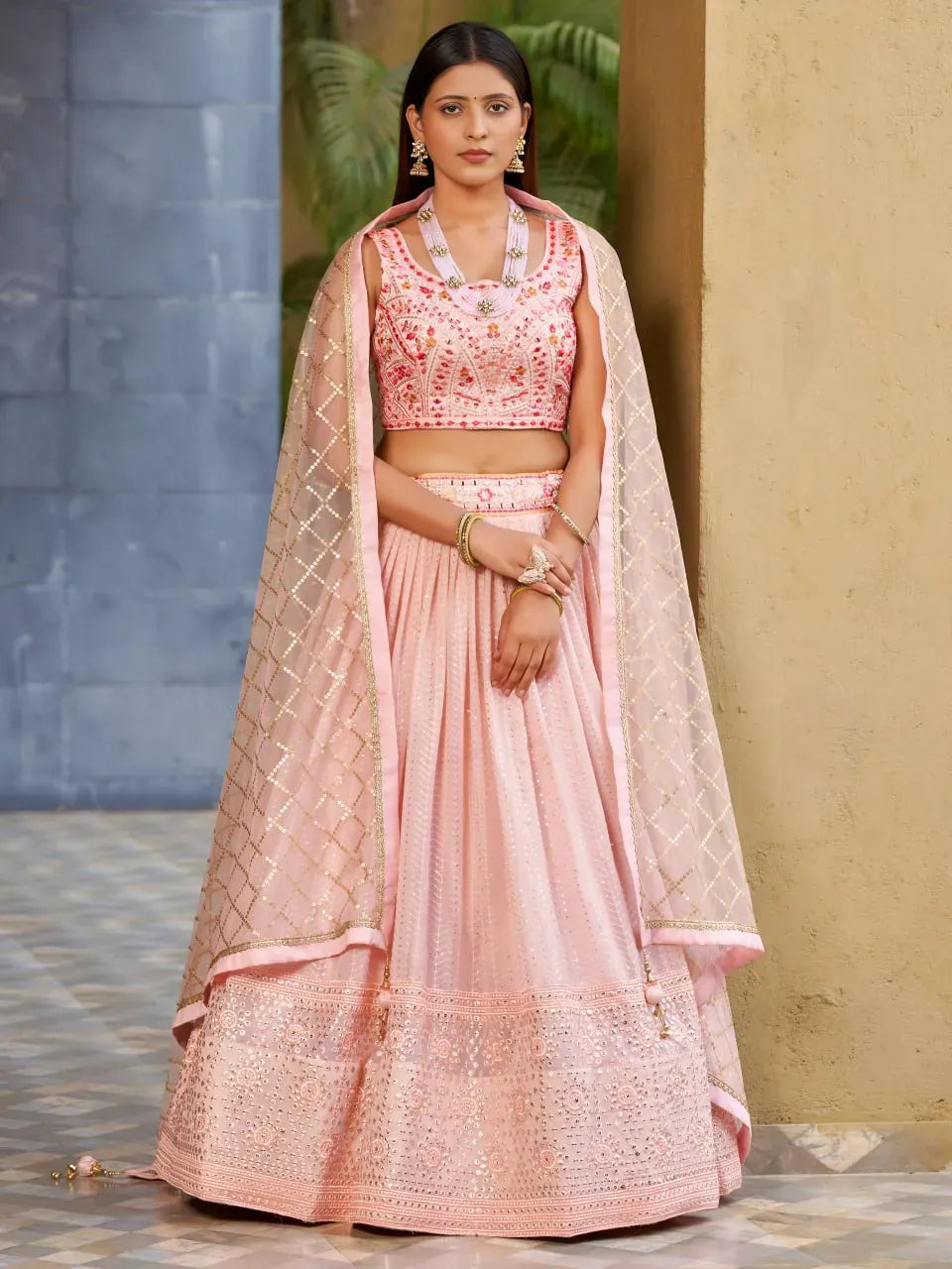 Model wearing blush pink mirror embellished lehenga front view