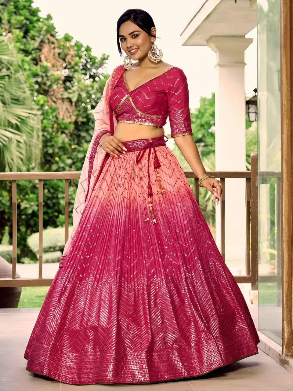 Model wearing fuchsia pink ombre lehenga with sequin work and dupatta