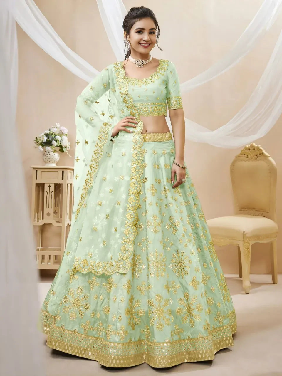 Model wearing pista green foil mirror work lehenga choli with dupatta