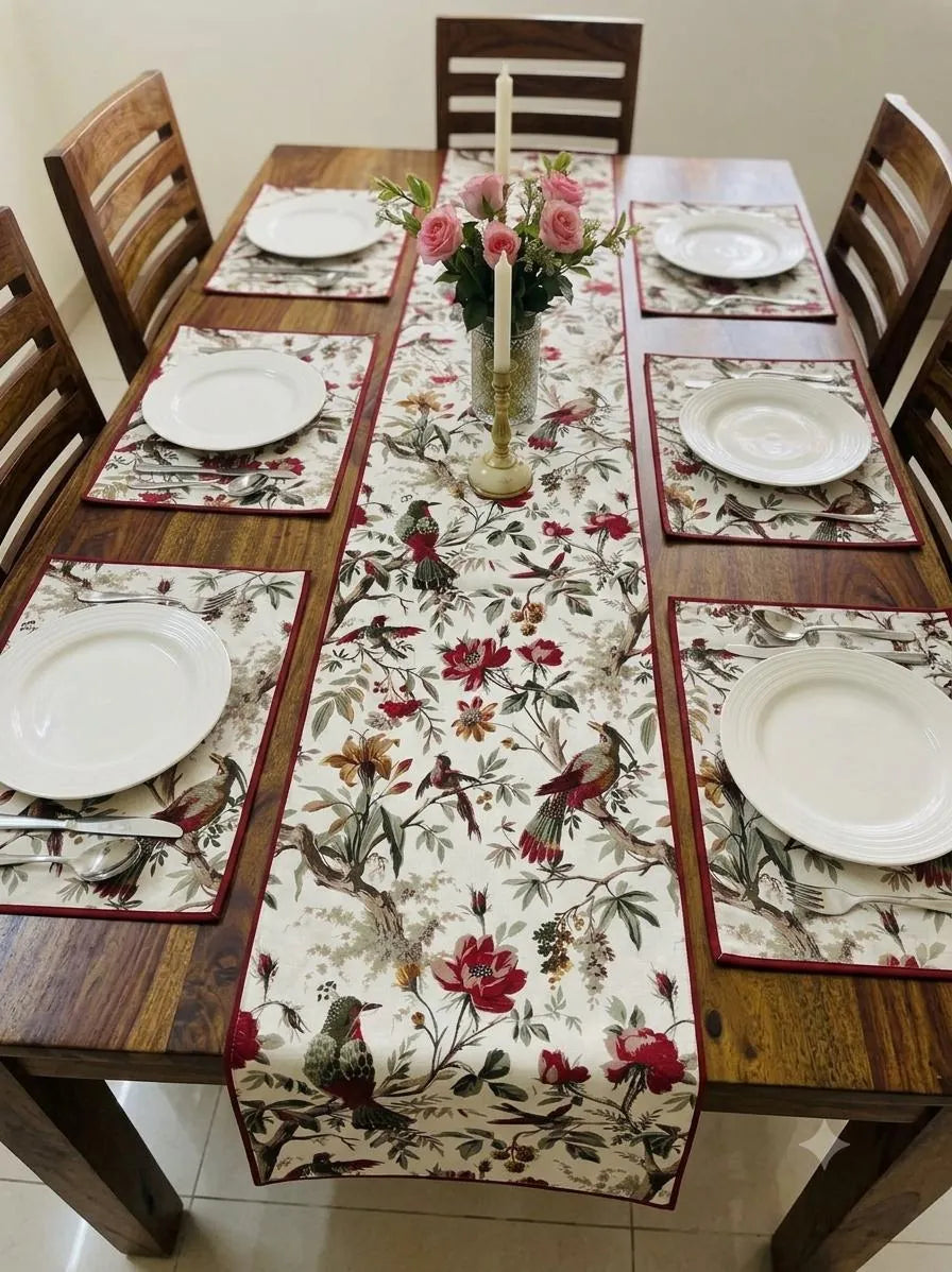 Red floral printed casemat table runner and placemats set on wooden dining table
