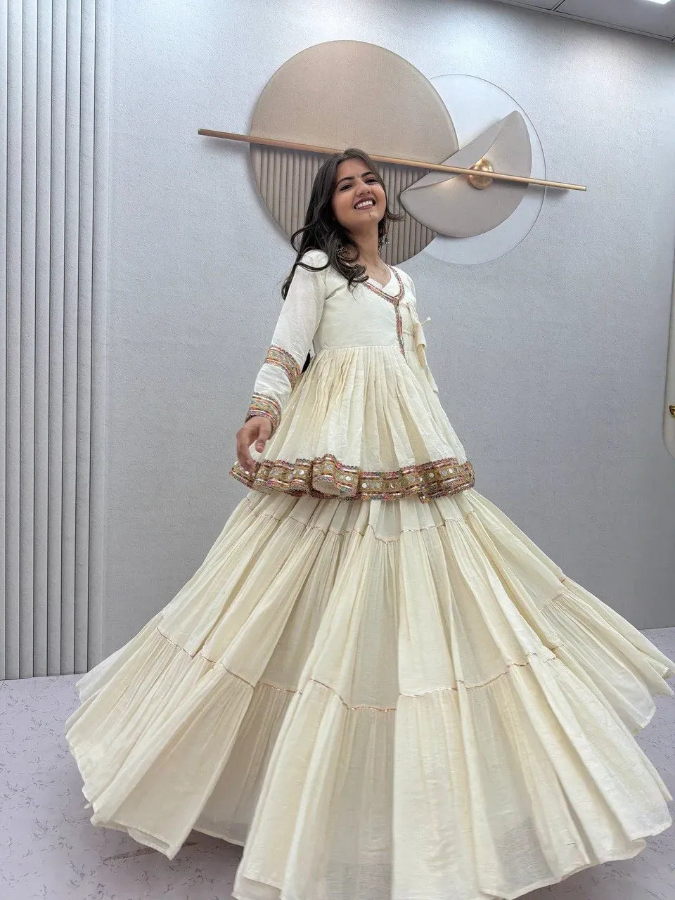 Smiling model wearing a white pure cotton kediyu lehenga with flared skirt