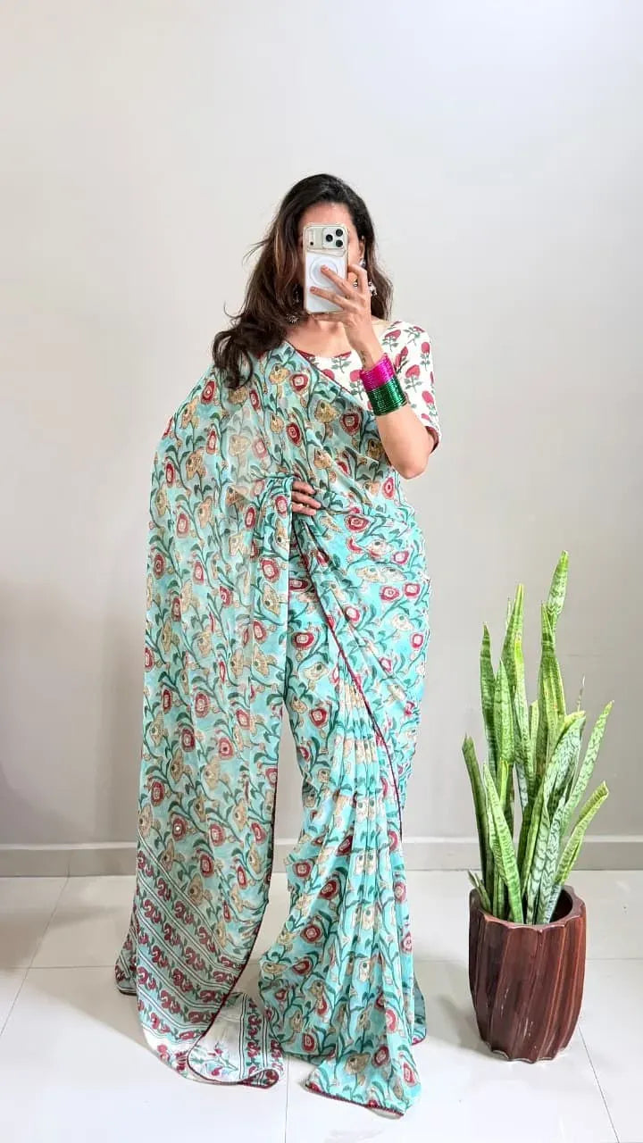 Full body view of woman in light blue shibori print georgette saree with mirror work
