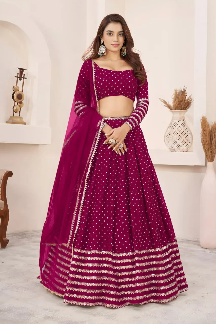 Model wearing radiant rani pink georgette lehenga choli with silver butti work and net dupatta