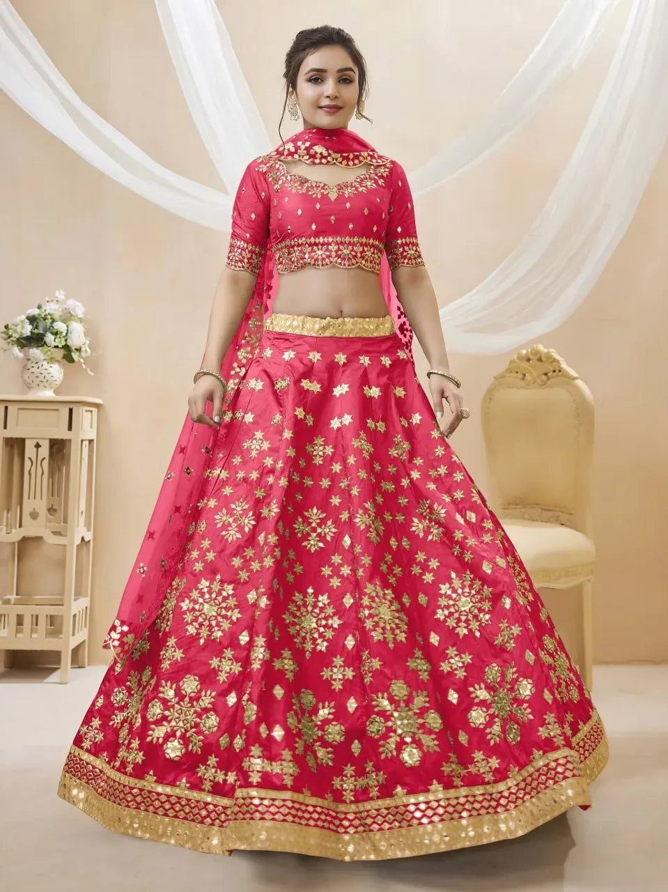 Front view of model standing in flared rani pink festive lehenga