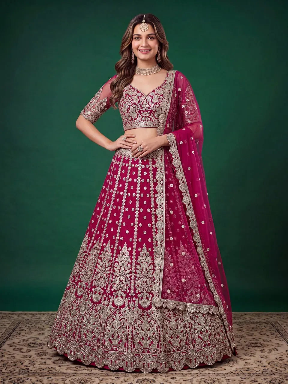 Front view of woman wearing heavy zari and sequins work rani pink lehenga