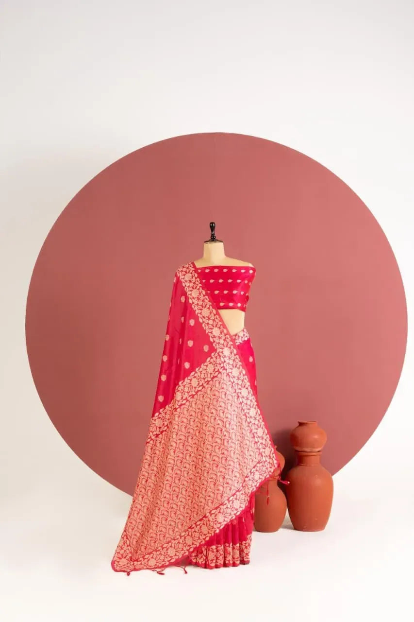 Red raw silk saree displayed on mannequin with pottery