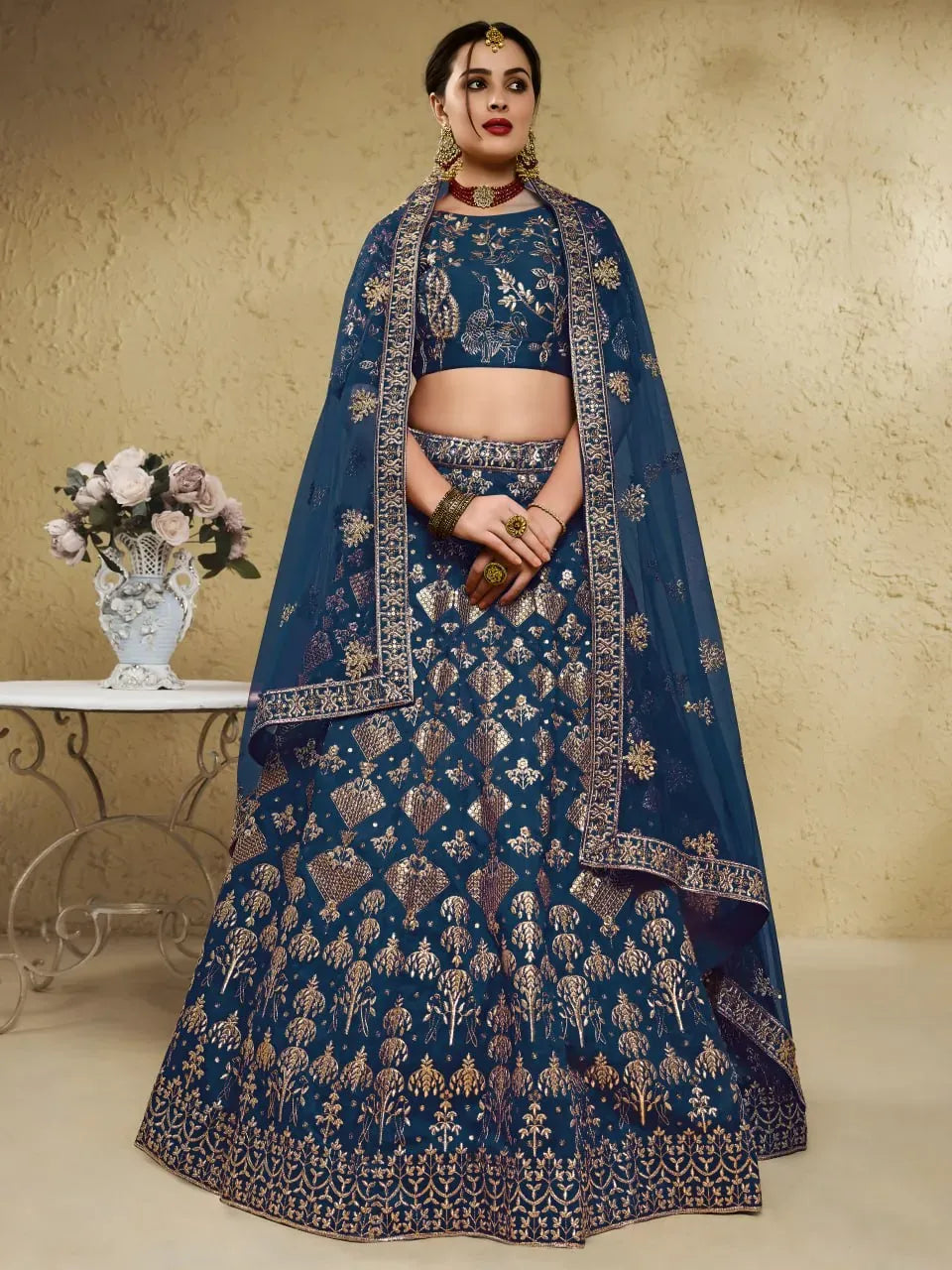 Model wearing royal teal blue heritage embroidered lehenga with dupatta front view
