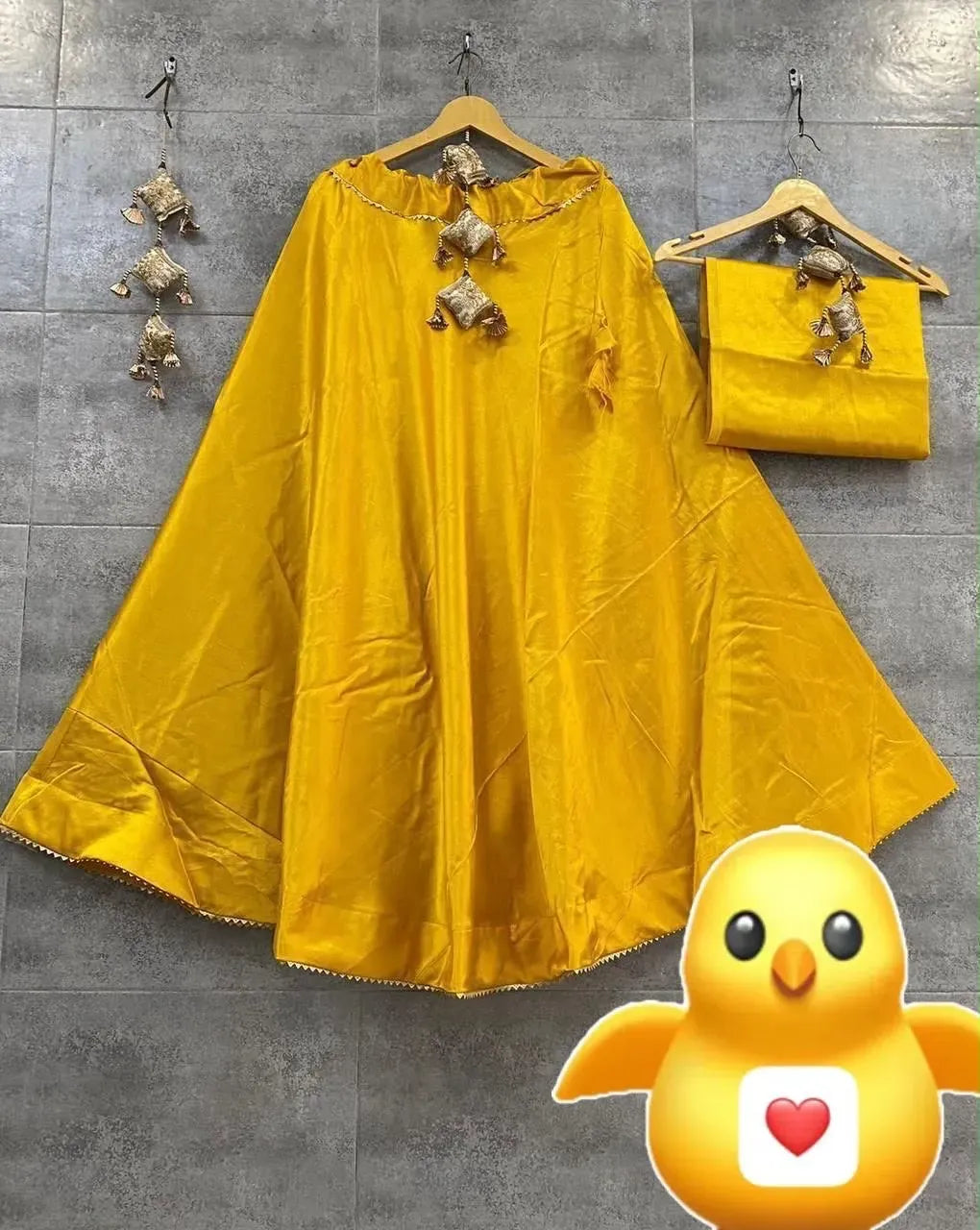 Yellow semi gaji silk skirt and blouse set hanging on wall