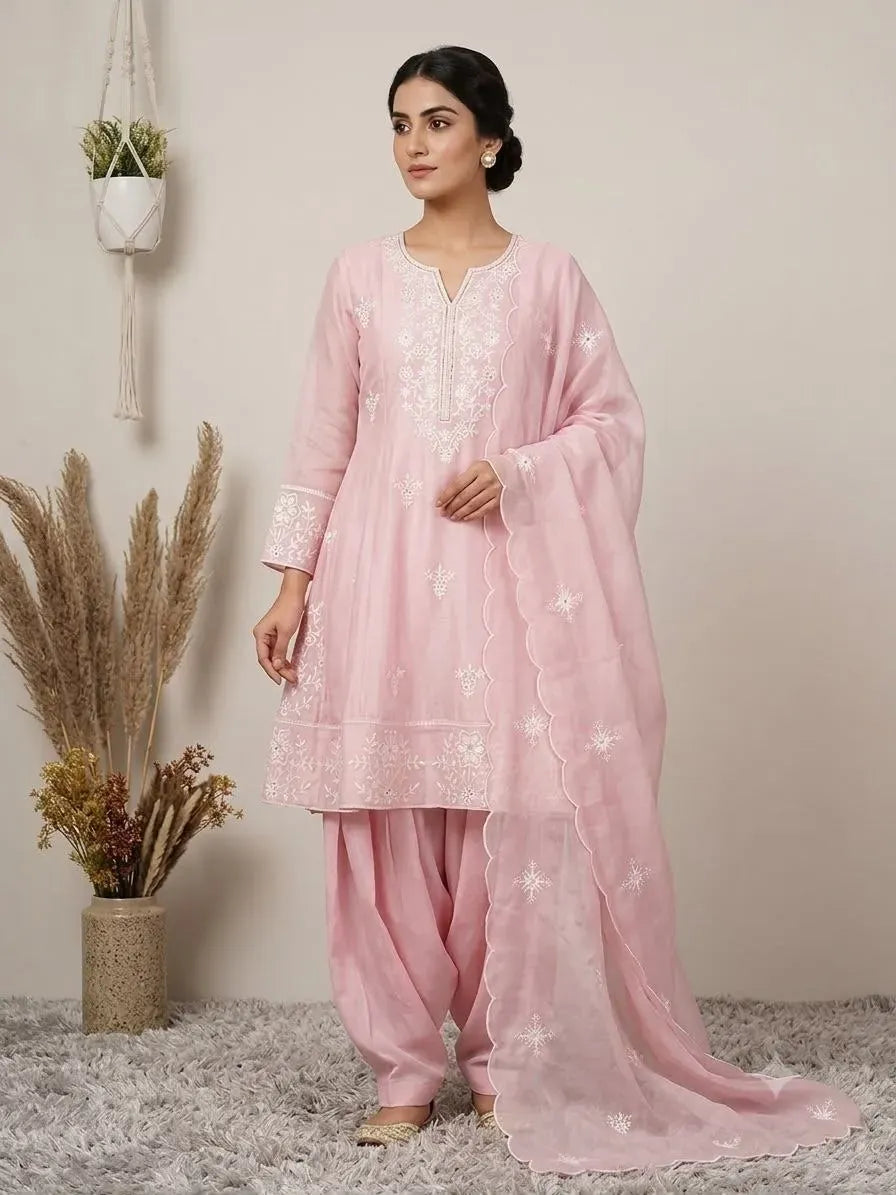 Model wearing pink sequence embroidered salwar kameez set with dupatta standing front facing