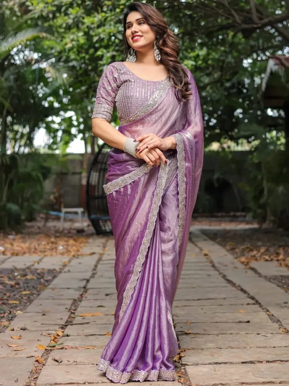 Model wearing a lavender fandy chiffon saree with sequence work border