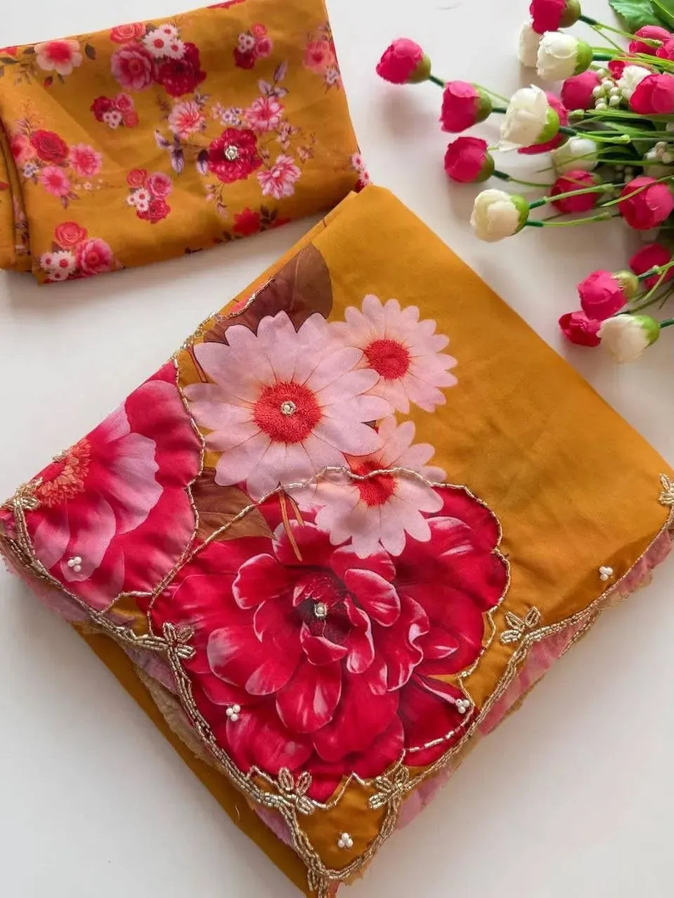 Folded mustard yellow georgette saree with floral handwork and matching blouse
