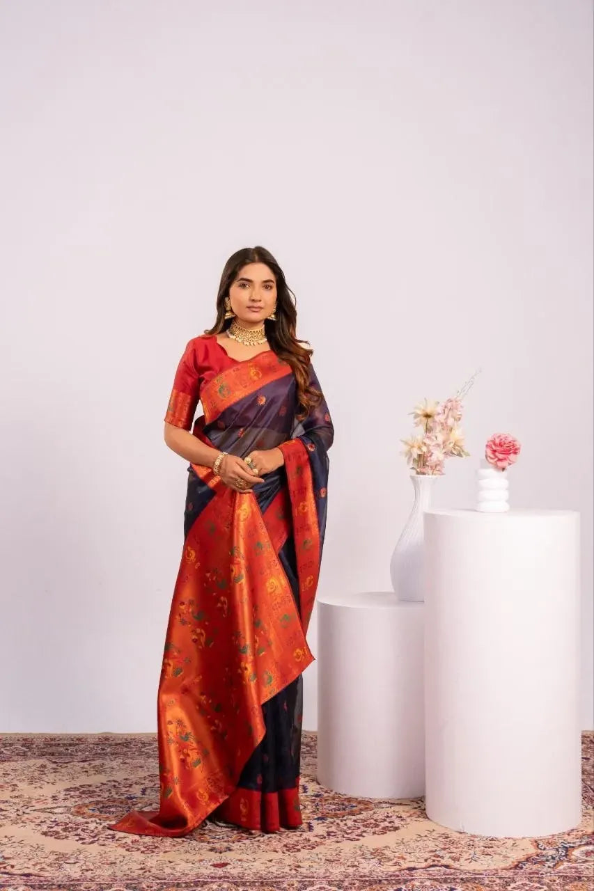 Model wearing navy blue soft tissue silk paithani saree with red pallu