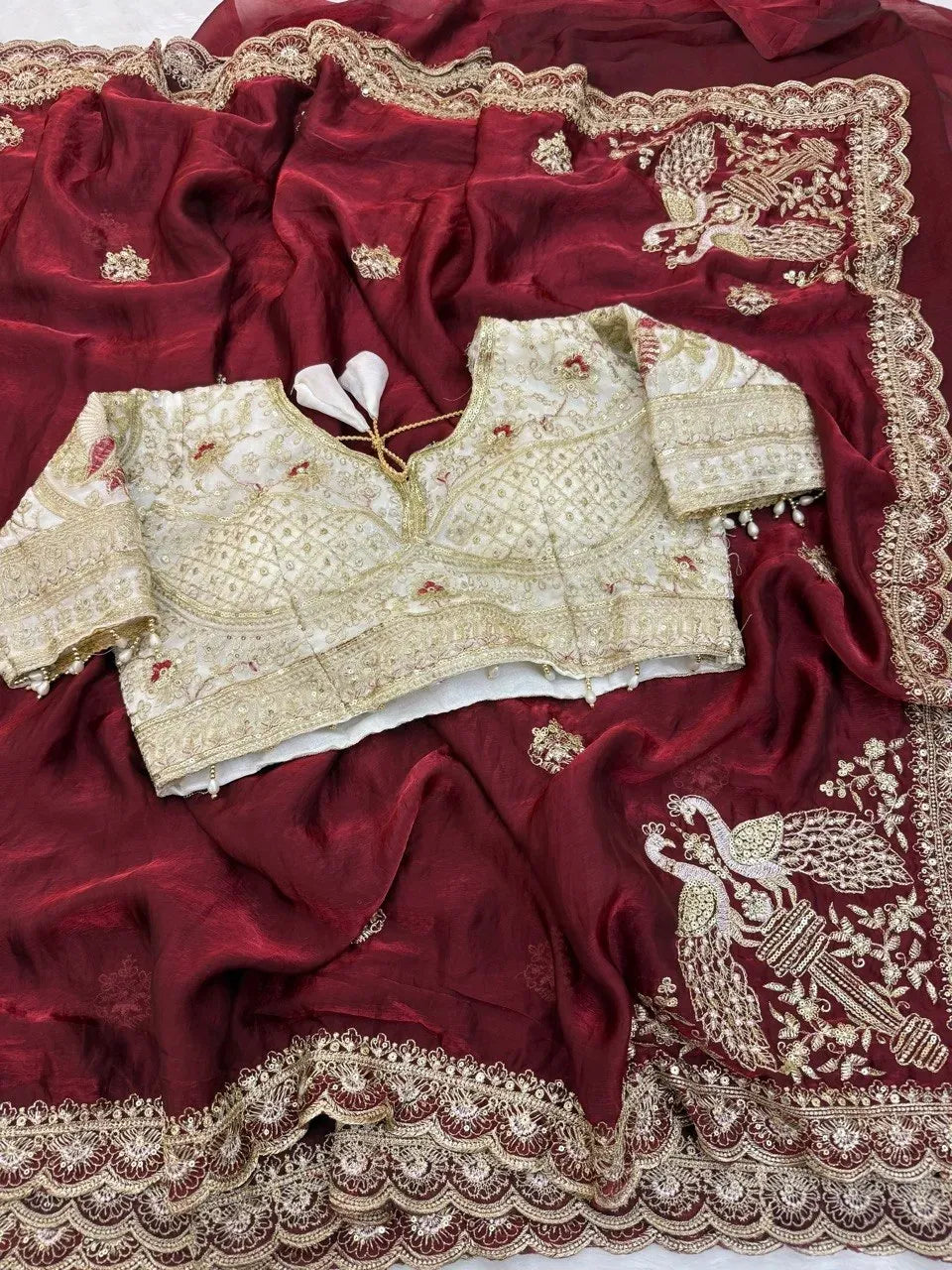 Maroon space satin saree with detailed peacock embroidery and matching blouse