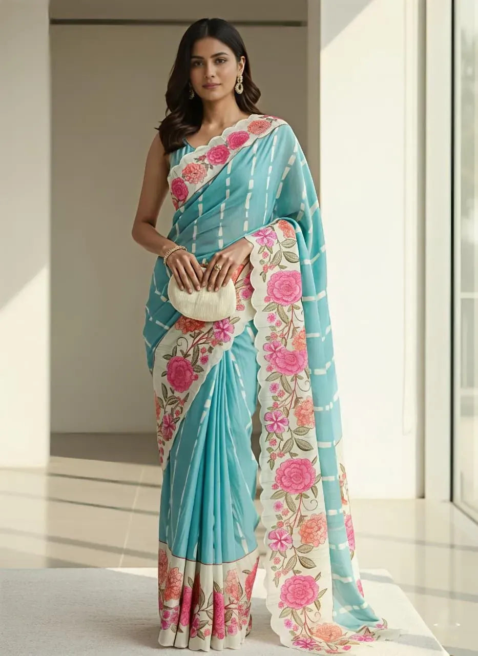 Model wearing light blue tussar silk saree with floral print and matching clutch