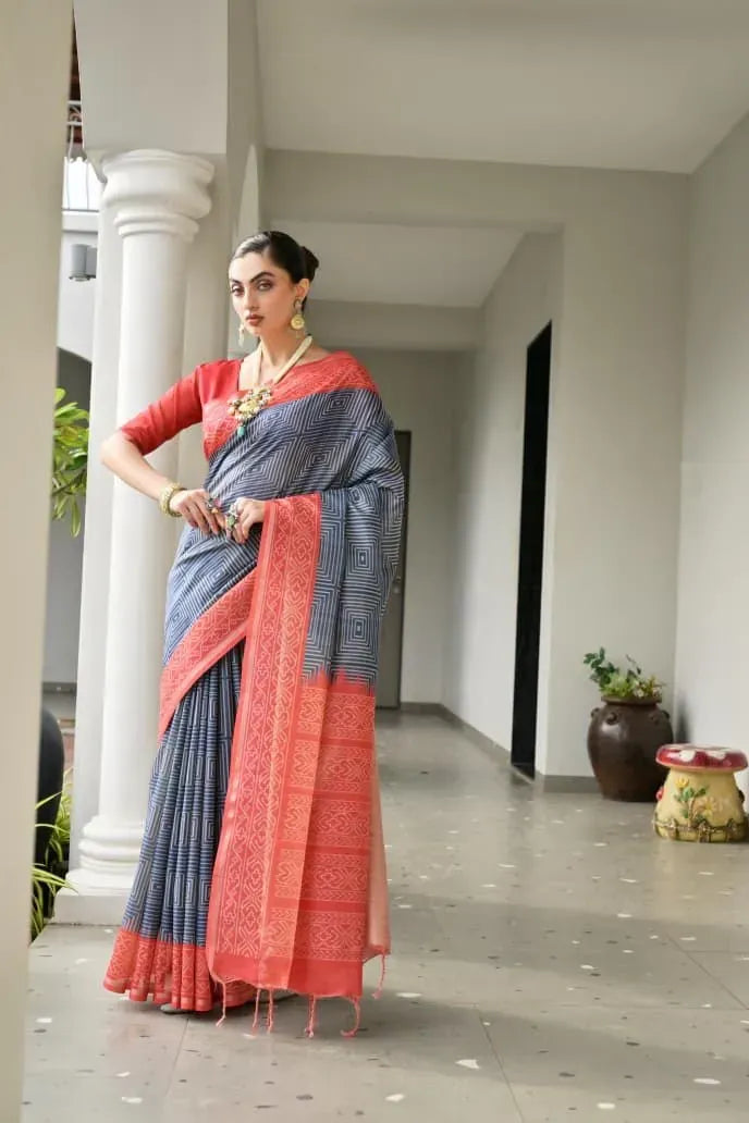 Model wearing grey soft tussar silk saree with red ikkat pallu and border