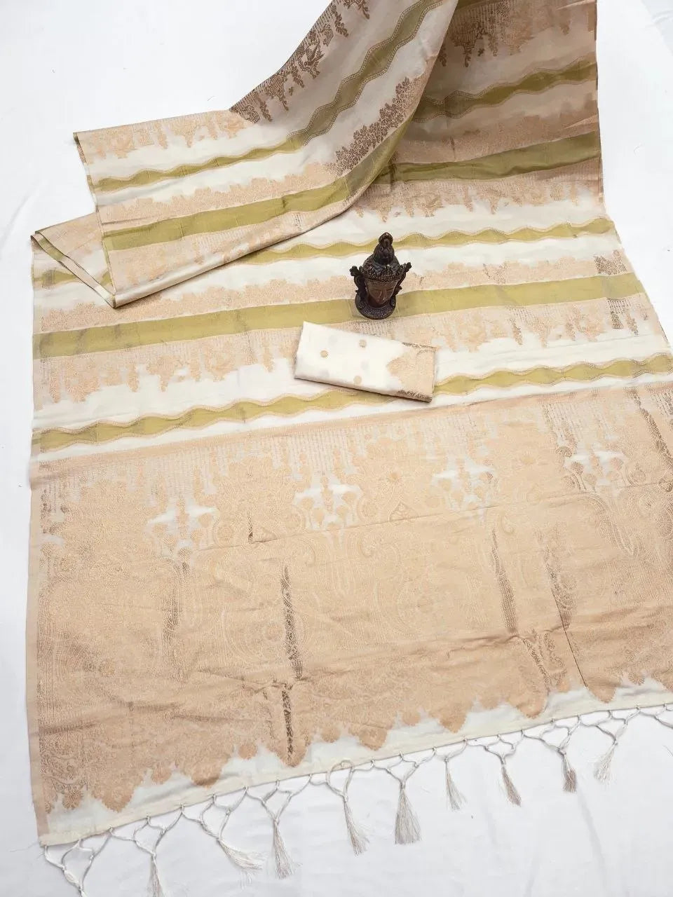 Cream tussar silk saree flat lay with gold zari weaving and matching blouse