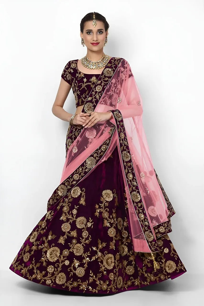 Front view of model wearing purple velvet lehenga choli with pink dupatta