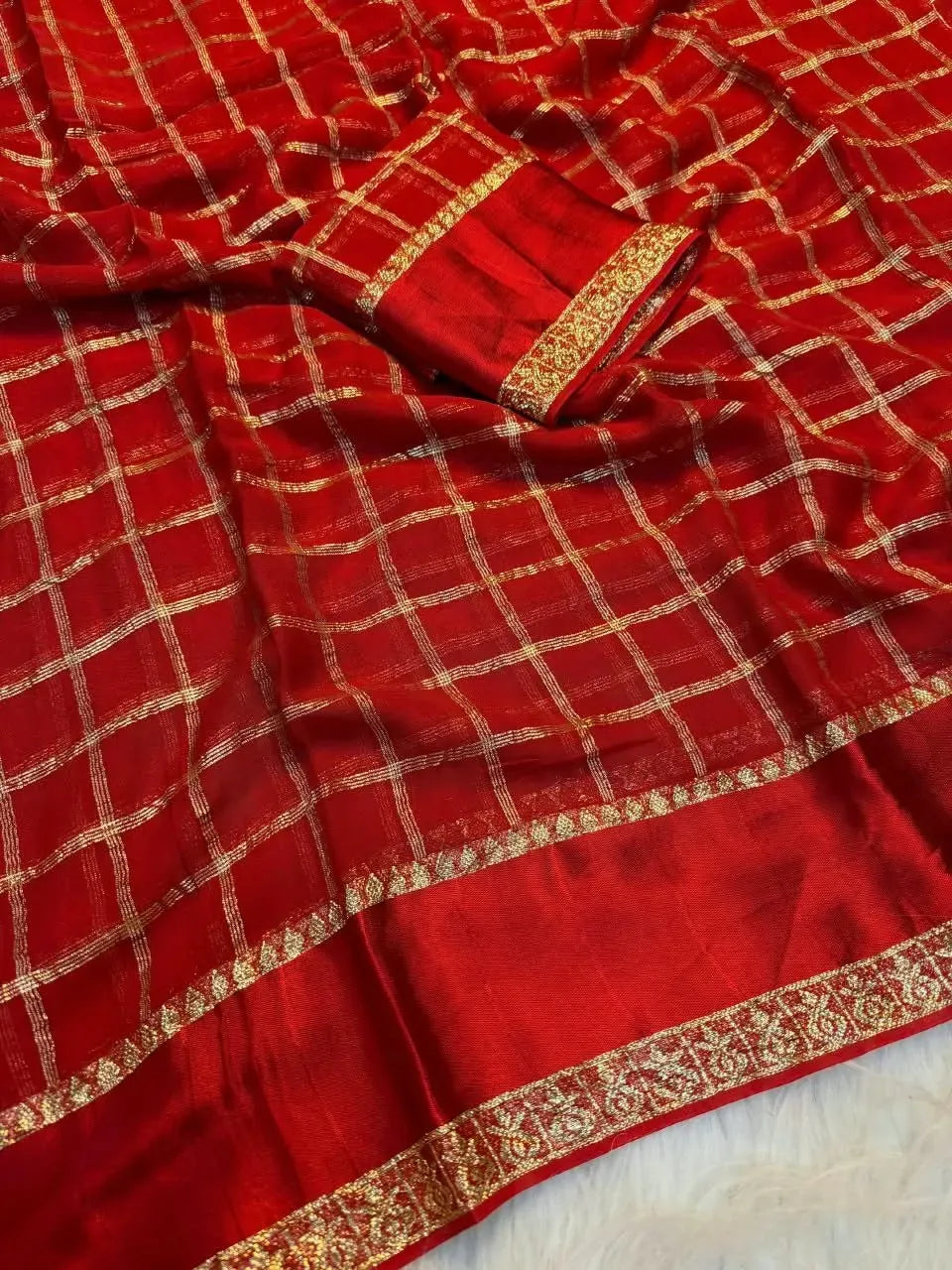 Red viscose georgette saree with gold checkered pattern and zari border