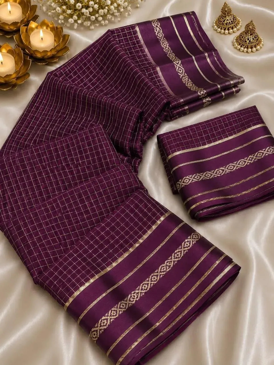 Folded purple viscose georgette saree with satin border and earrings
