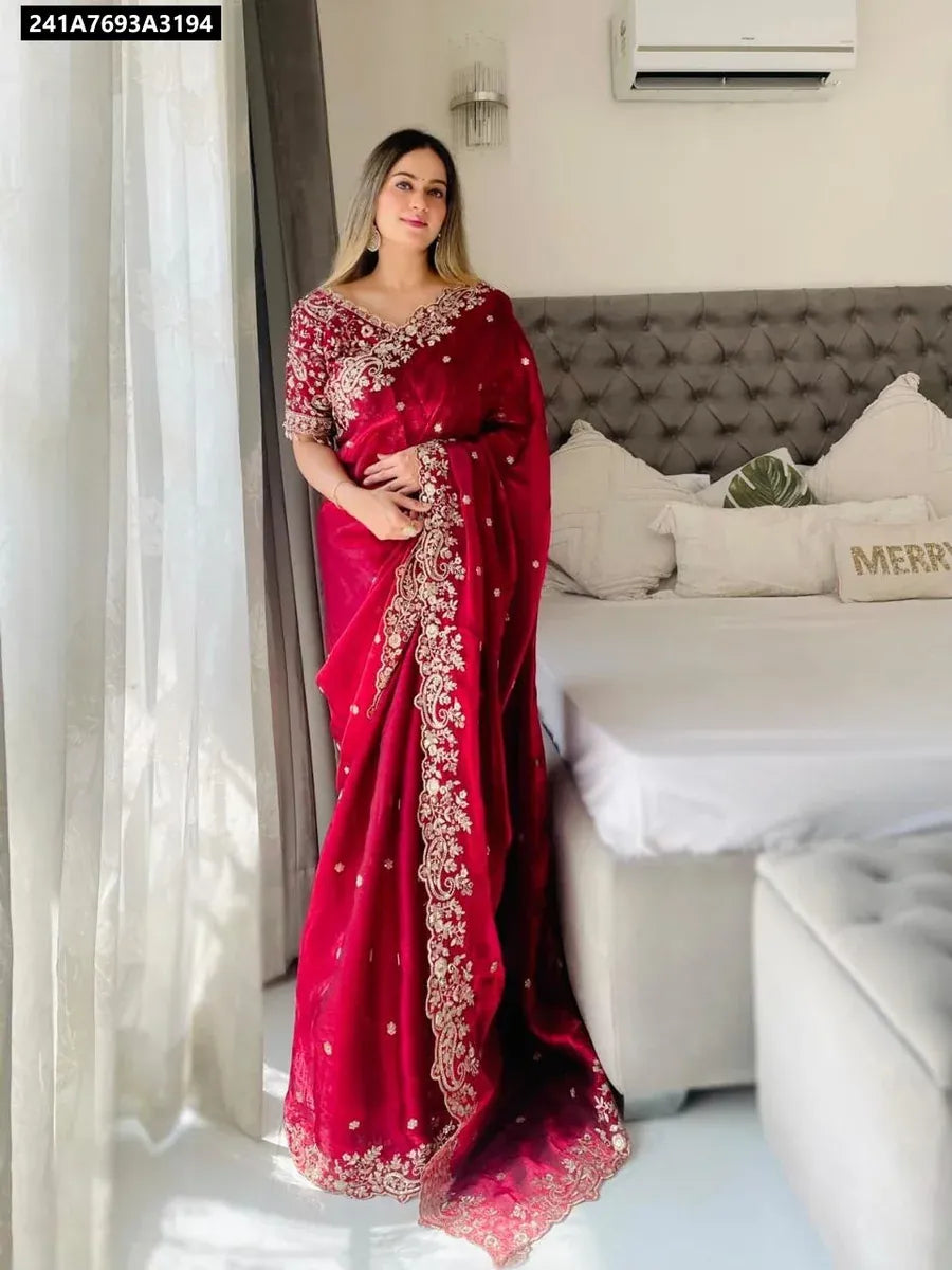 Full body view of a model elegantly posing in a maroon fandy satin embroidered saree