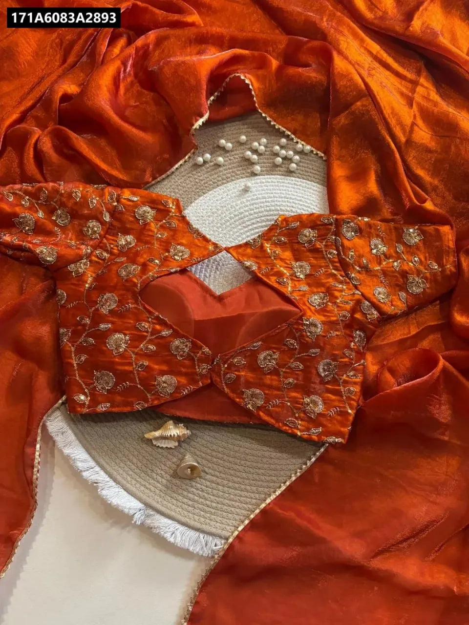 TRENDBUY Pure Fandy Satin Saree with open sequins embroidered blouse in burnt orange, flat lay.