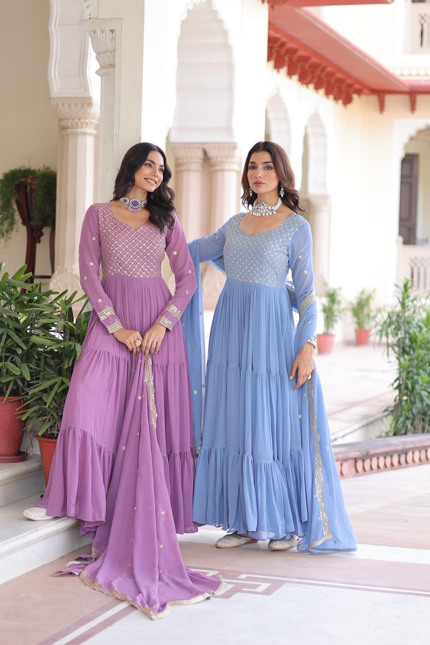 Two models showcasing lavender and sky blue tiered faux georgette Anarkali gowns with dupattas.