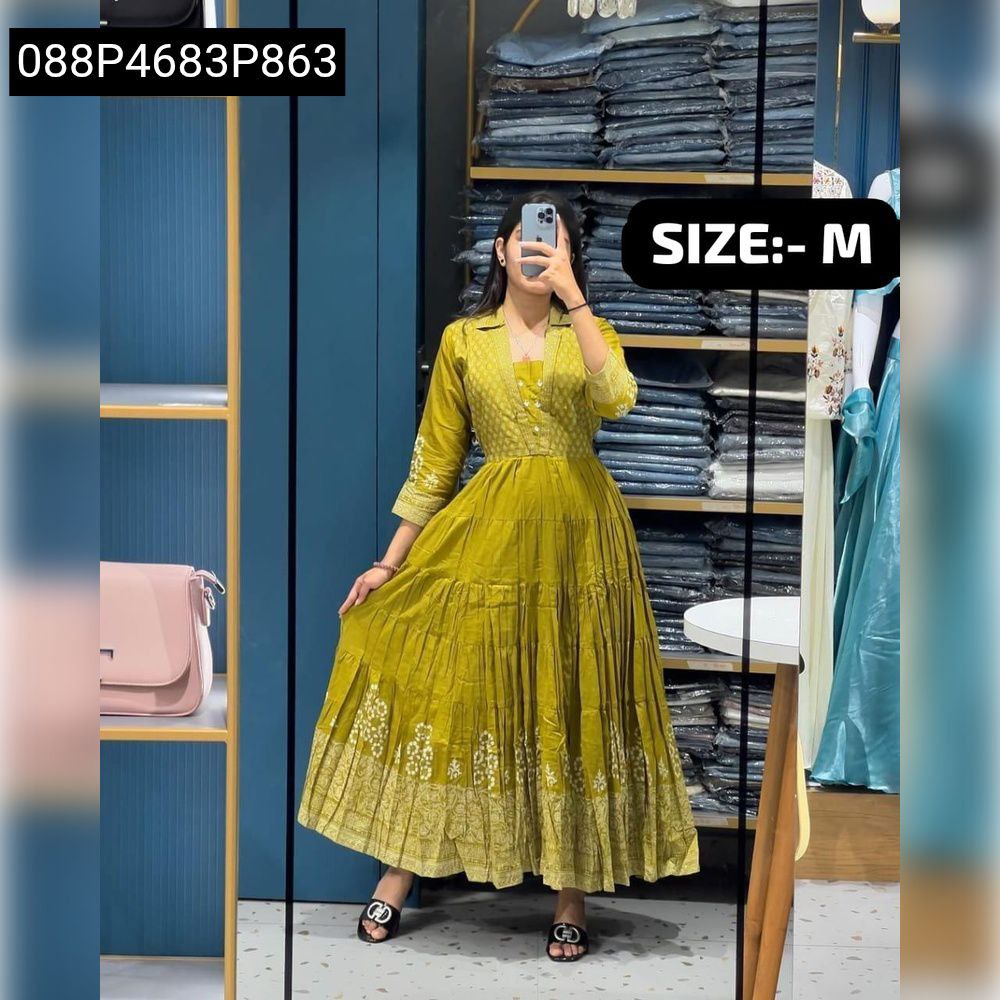 Model posing in olive green embroidered tiered kurti pant set, full body shot.