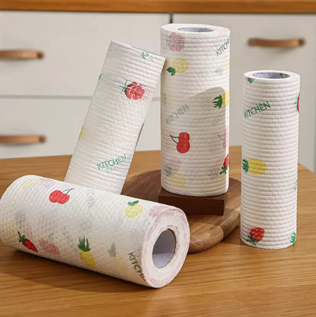 Four rolls of paper towels with fruit patterns on a wooden surface.
