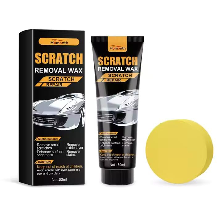 Hand applying car scratch repair paste to a scratch on a red car.
