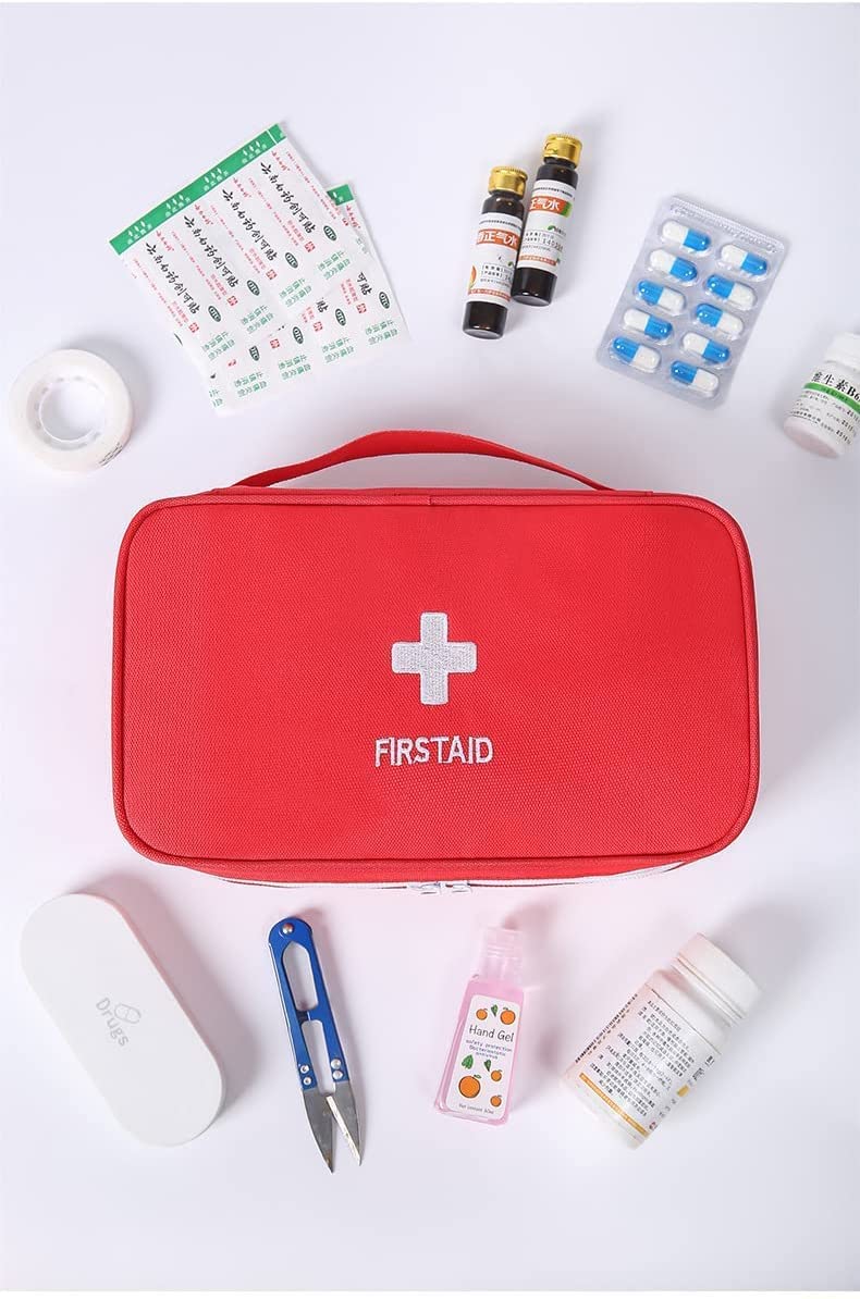 Red first aid travel medicine pouch open, displaying organized internal compartments and essential medical supplies.