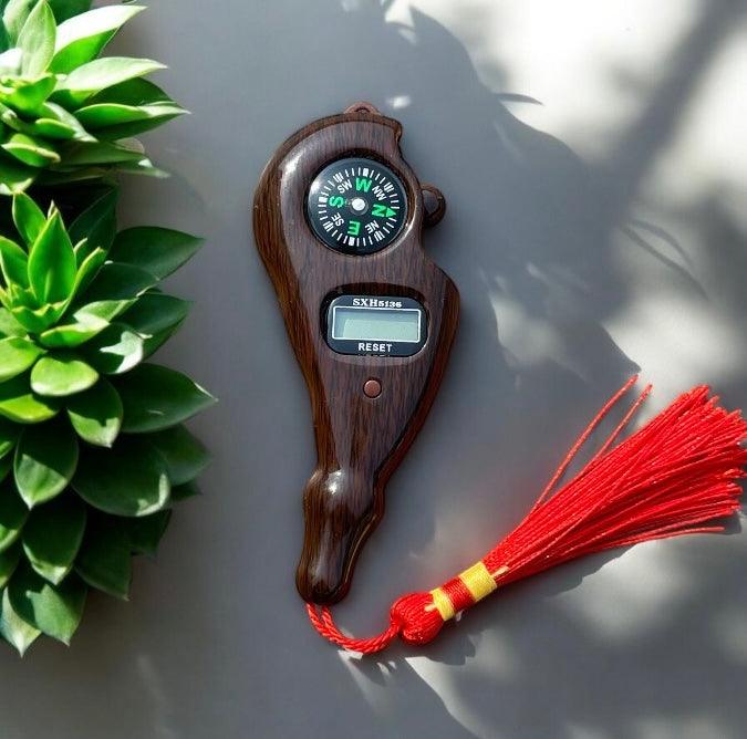 Handheld digital finger counter with integrated compass for accurate tallying.