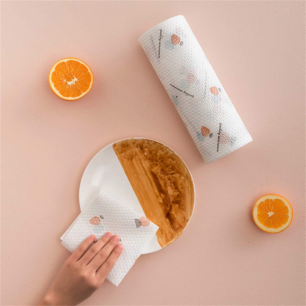 Roll of paper towels with a decorative pattern on a pink surface with oranges and a plate.