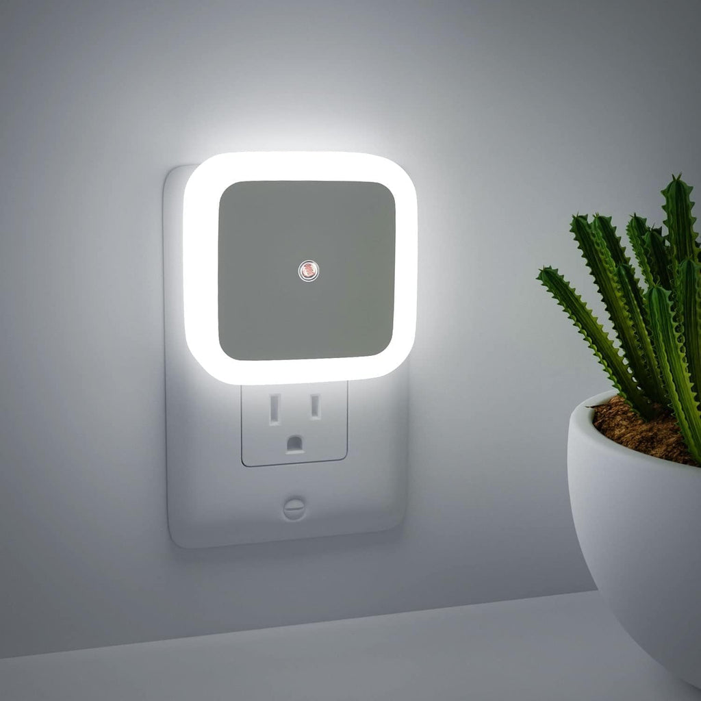 Compact white sensor night light illuminated with a soft glow