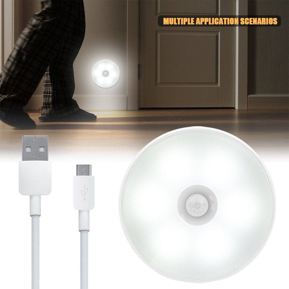 Wireless LED motion sensor light mounted on a wall, casting a warm glow.