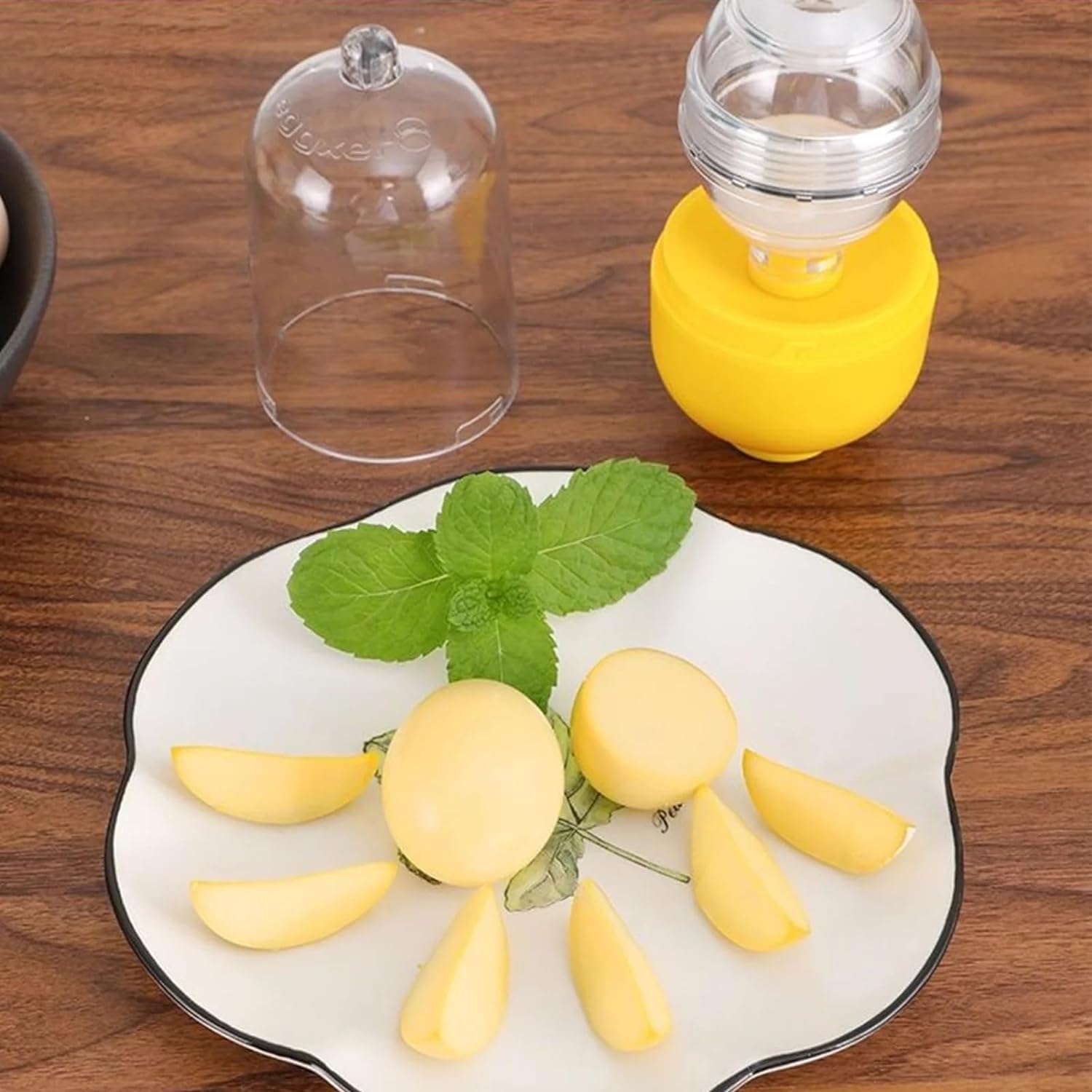 Yellow fruit slices on a white plate with green leaves, placed on a wooden surface.