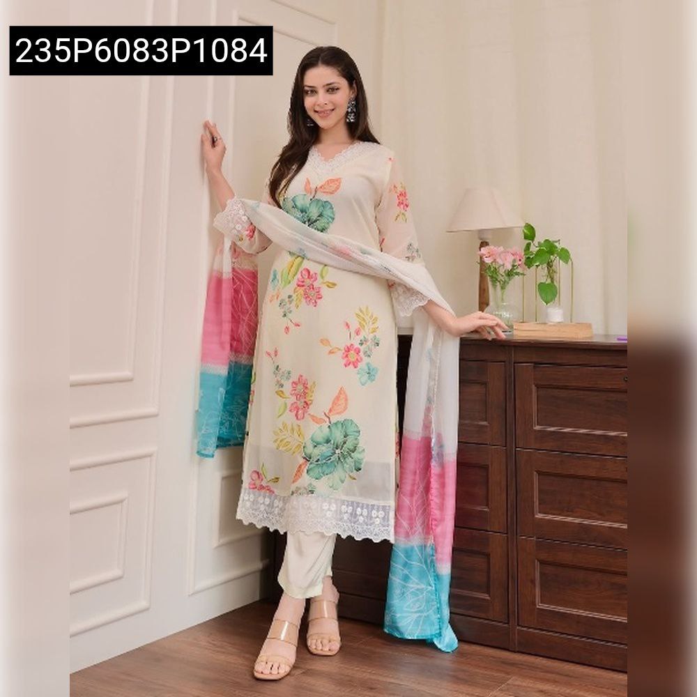 Woman posing in a full floral embroidered kurti set with matching pants and dupatta.