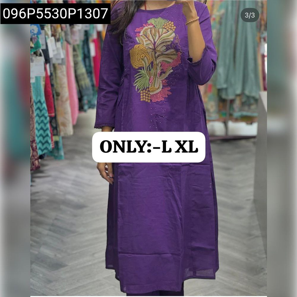 Model wearing lavender floral embroidered cotton kurti pant set.