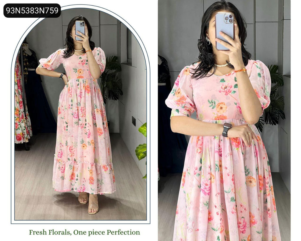 Woman posing in a pink floral print flairy kurti dress, showing the full length and frill details.