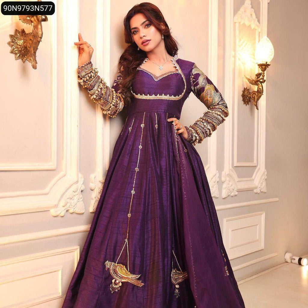 Full body shot of model in purple gown, leaning against wall, displaying full flair and bird embroidery.