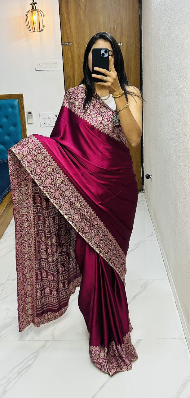 Woman posing in a deep pink Gajji Crepe Silk Saree with elaborate ethnic border, ideal for festive wear.
